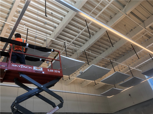 Acoustical tiles being installed in the JAMS choir room 